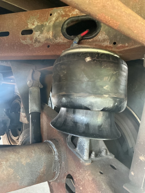 Mechanic inspecting trailer undercarriage